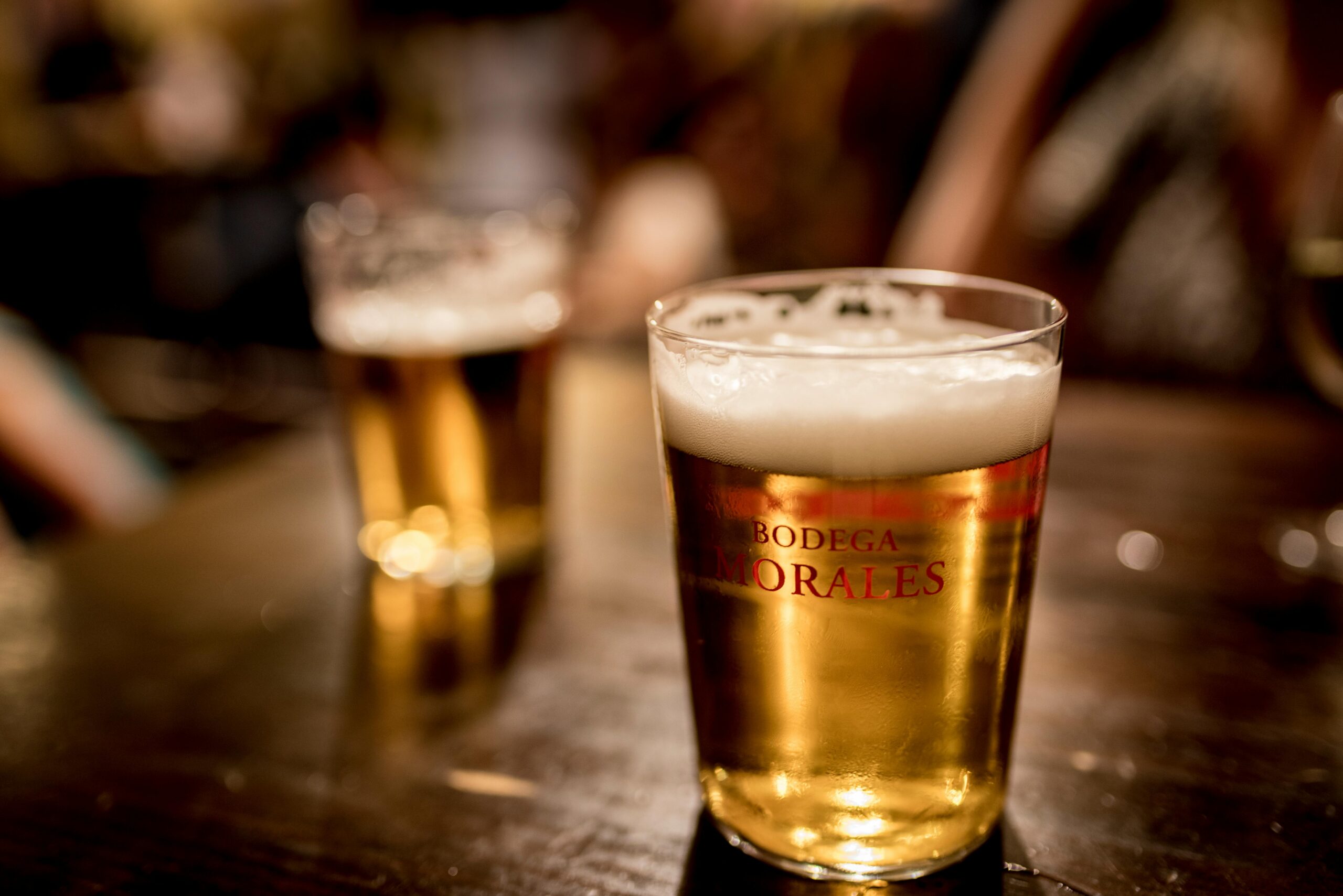 Close-up of a frothy beer in a Bodega Morales glass, Sevilla.